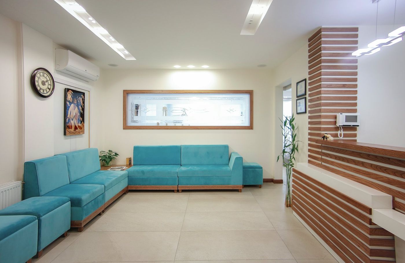 Waiting area with a blue couch and plant