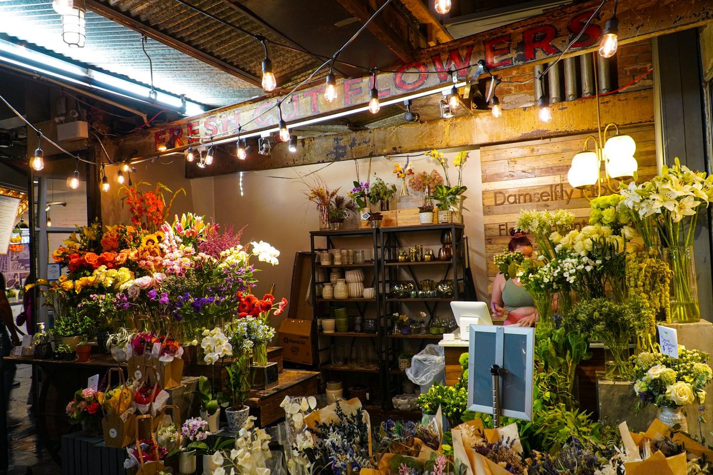 A flower shop full of buckets of fresh flowers