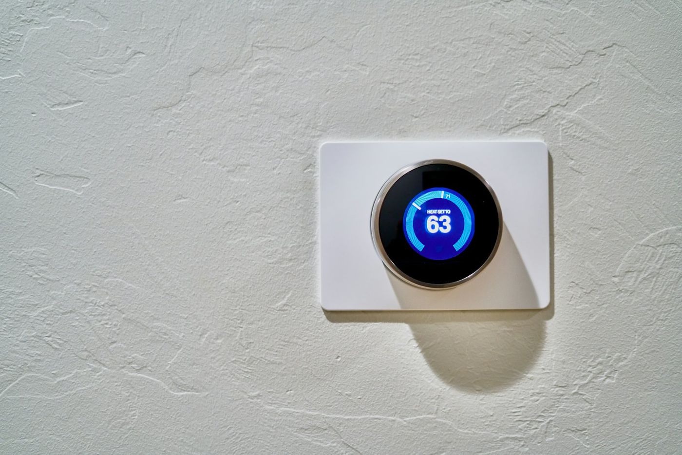 Smart thermostat on a white wall