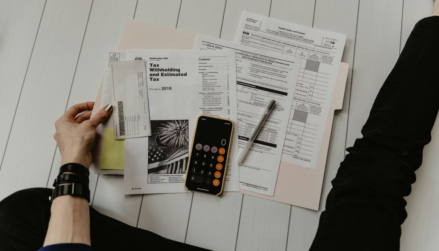 Paperwork, pen and calculator on a desk