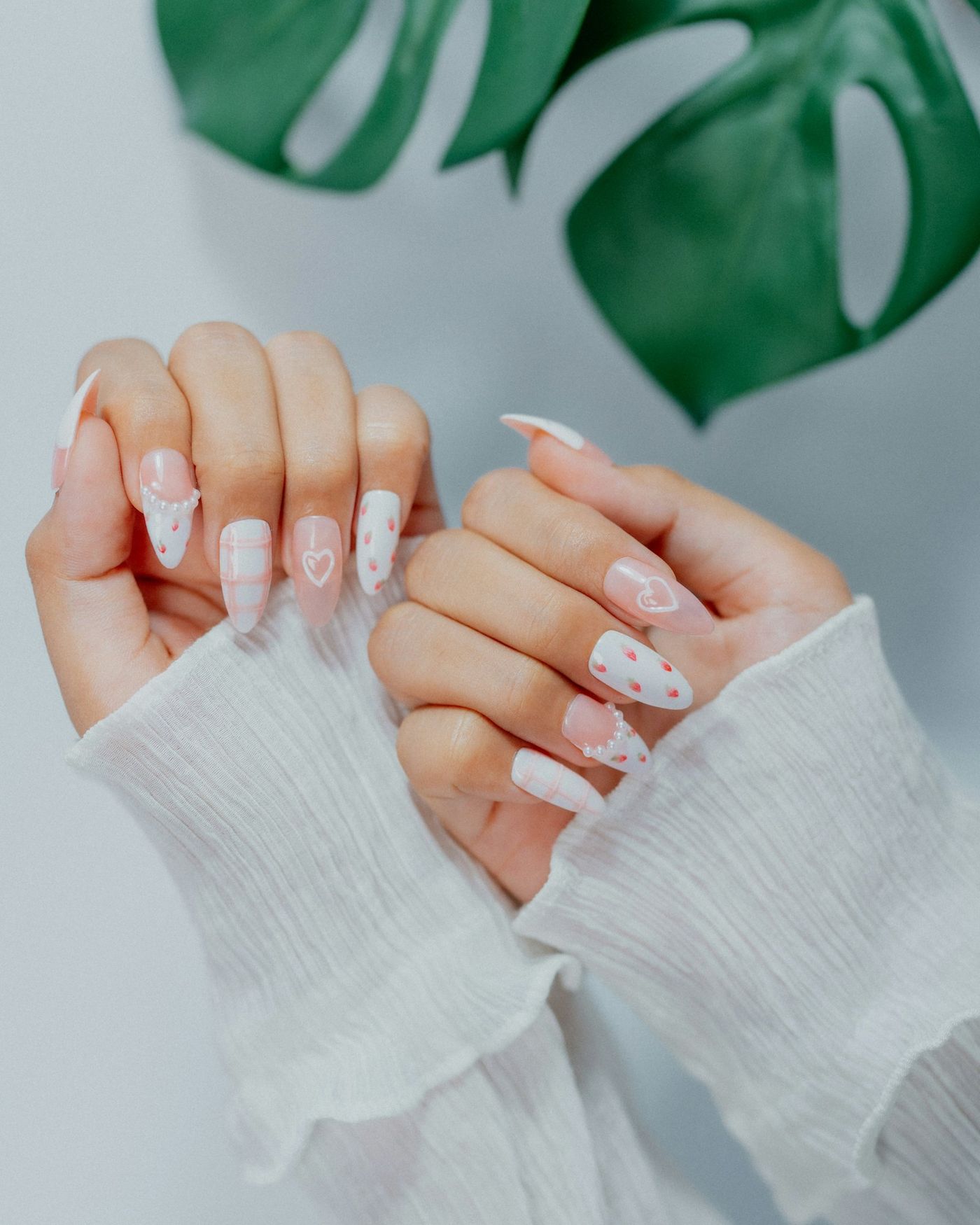 Soft white nails with tiny red heart details